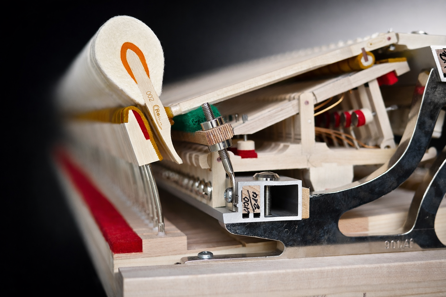 Close-up of a grand piano action and hammer assembly during regulation