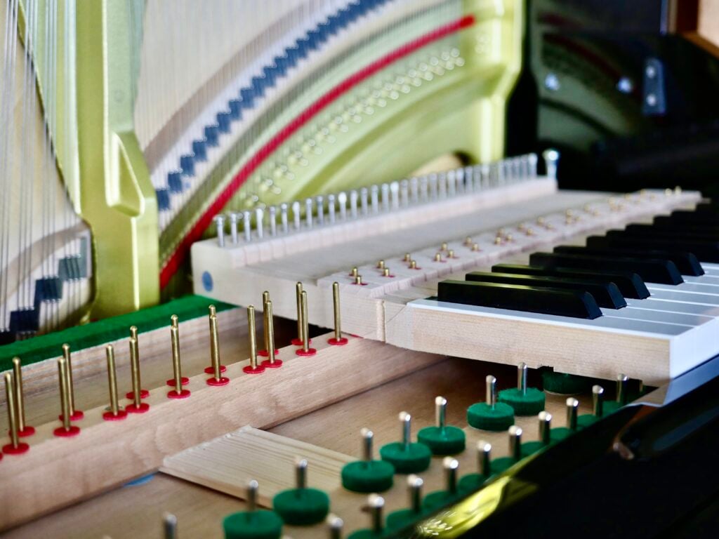 Interior of an upright piano with keys and action removed for servicing